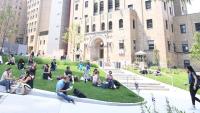 Students relaxing on a grassy lawn in CUIMC courtyard