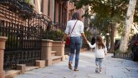 Mother and daughter walking down the street